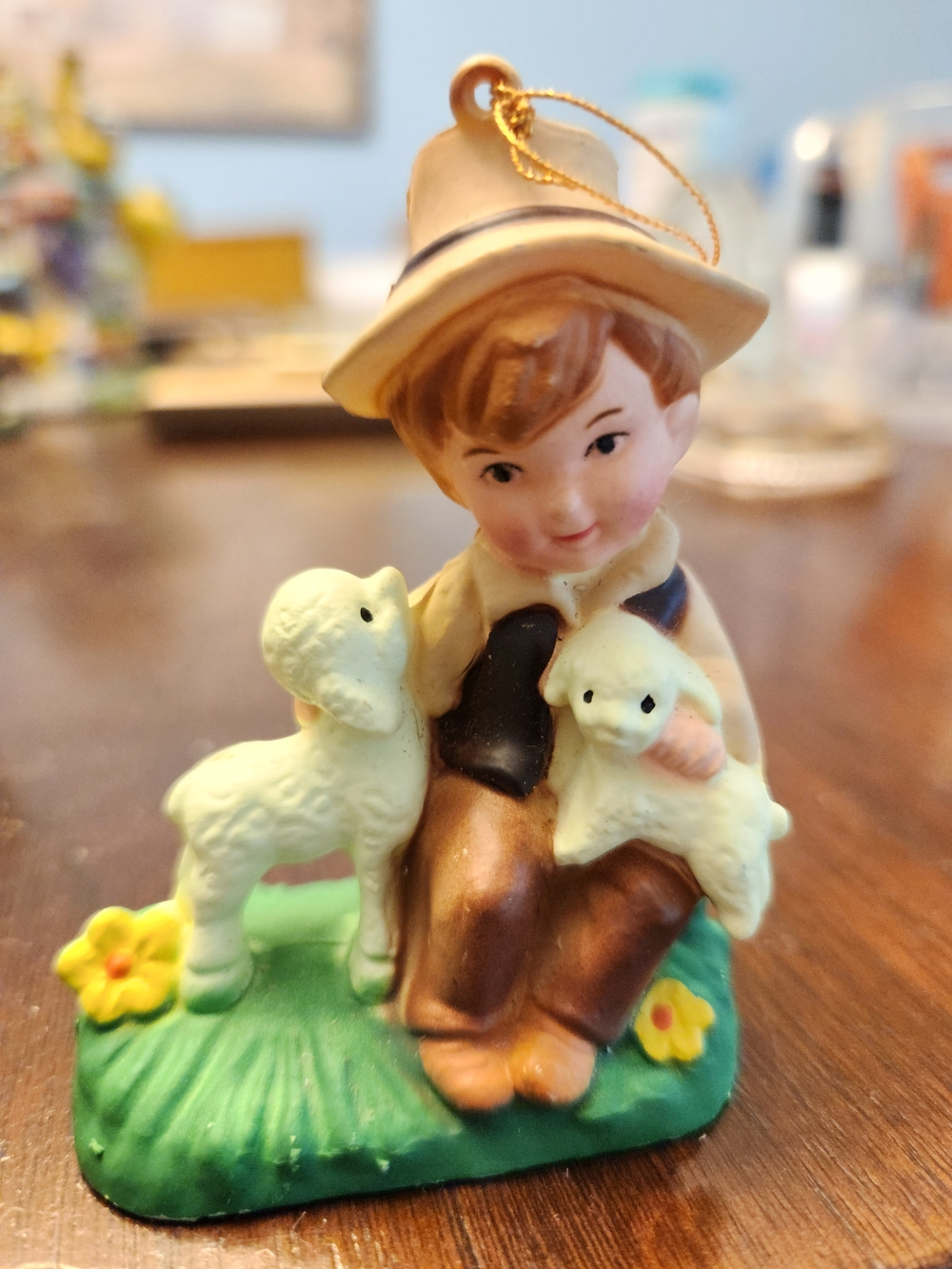 Source Unknown Brown-Clad Child Figurine with White Lambs on Green Base Ornament